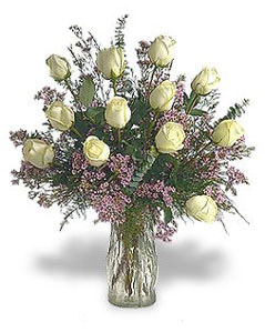 Dozen white roses in a glass vase