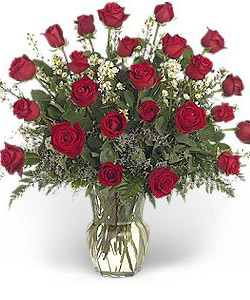 Two dozen red roses in a glass vase