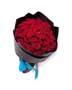 Bouquet of red roses in kraft paper